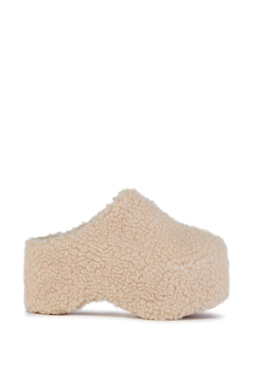 cream faux sherpa slip on mule with a curved platform sole