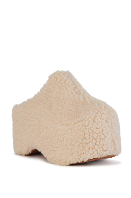 cream faux sherpa slip on mule with a curved platform sole