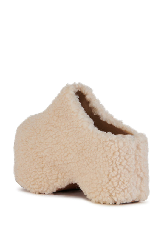 cream faux sherpa slip on mule with a curved platform sole