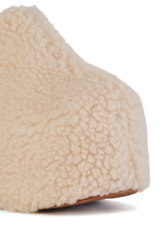 cream faux sherpa slip on mule with a curved platform sole