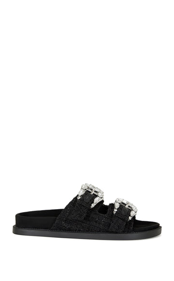 black slip on flat sandal with a tweed upper with double straps featuring silver rhinestone studded belted accents on each strap
