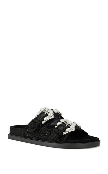 black slip on flat sandal with a tweed upper with double straps featuring silver rhinestone studded belted accents on each strap