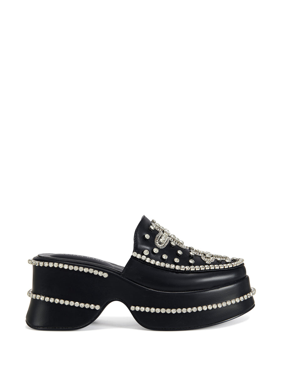 black faux leather slip on mules with a cross design rhinestone embellishment on the upper