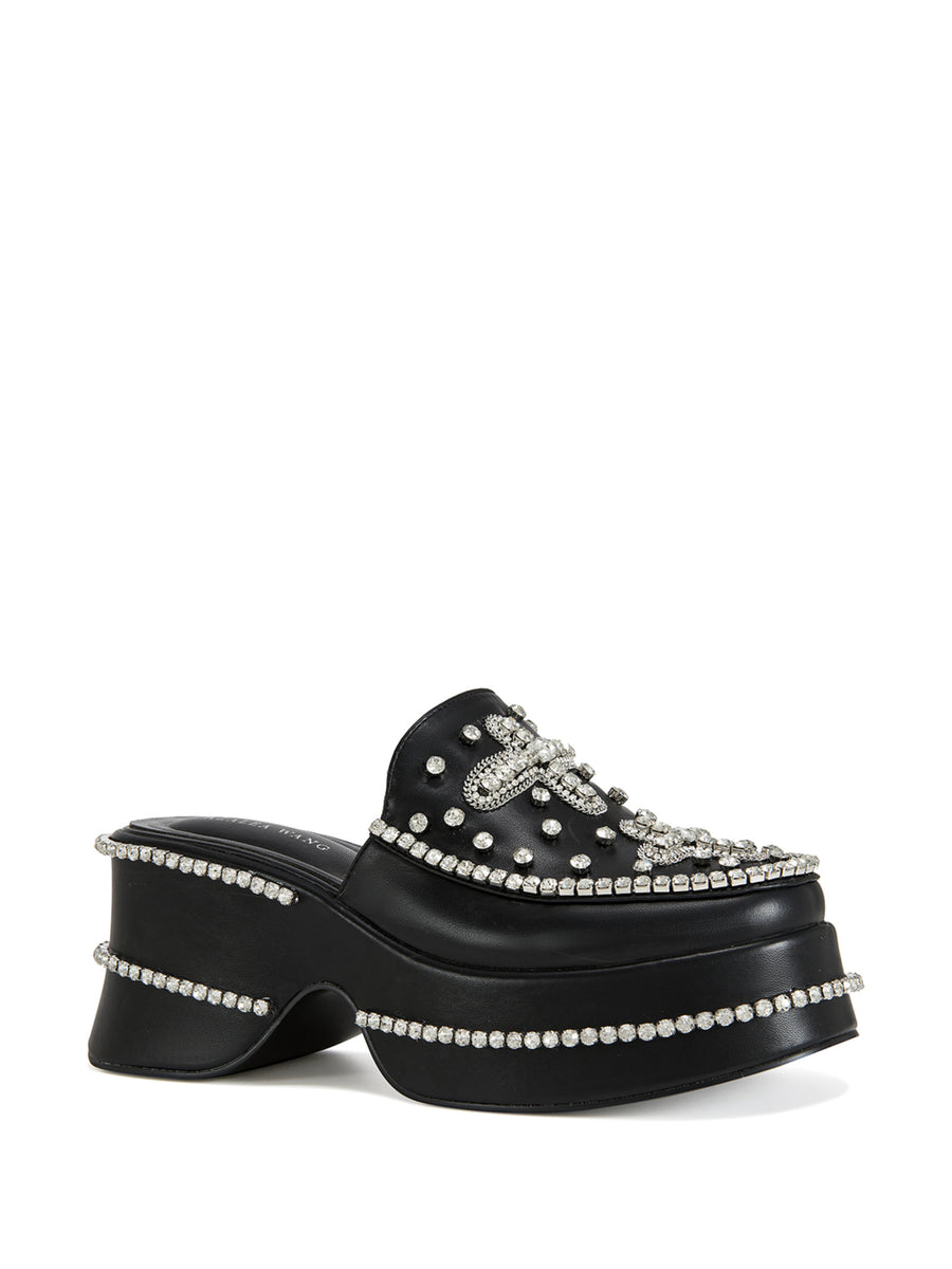 black faux leather slip on mules with a cross design rhinestone embellishment on the upper