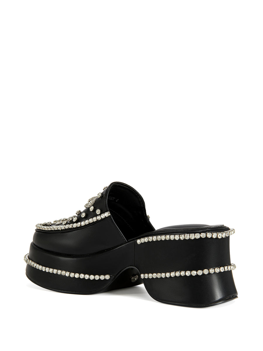 black faux leather slip on mules with a cross design rhinestone embellishment on the upper