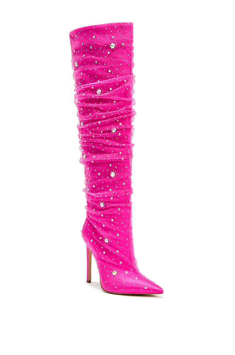 angled view of knee high hot pink stiletto boots with a pointed toe and rhinestone embellished mesh overlay