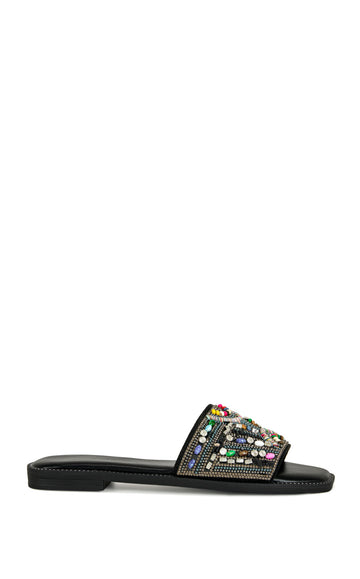 black faux leather slip on flat sandal with a colorful crystal embellished foot strap