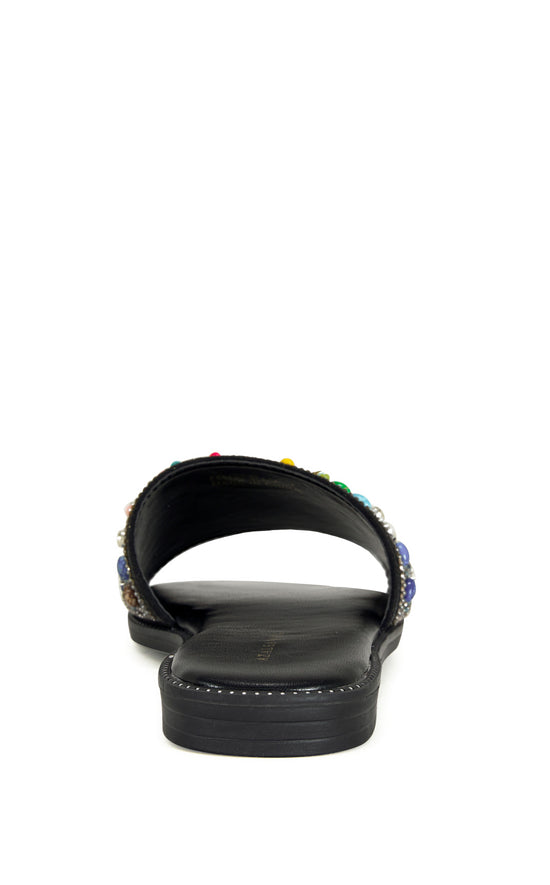 black faux leather slip on flat sandal with a colorful crystal embellished foot strap