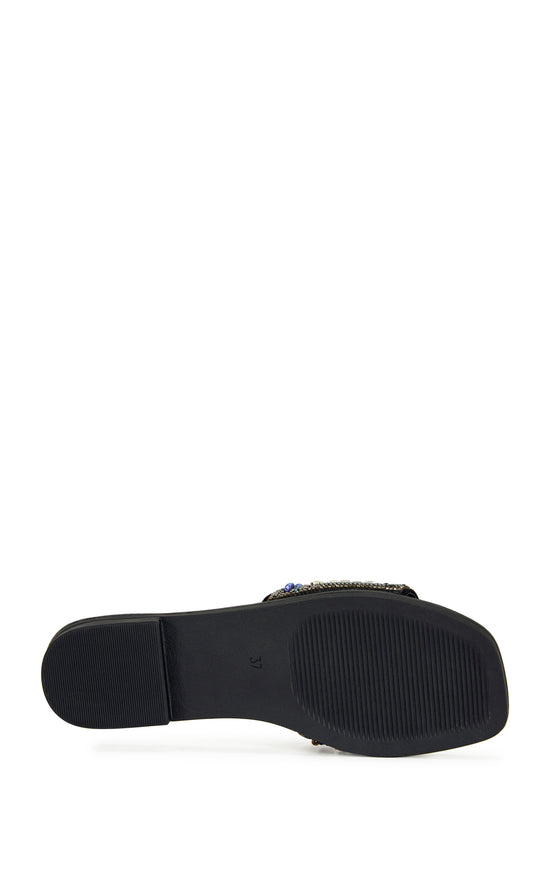 black faux leather slip on flat sandal with a colorful crystal embellished foot strap