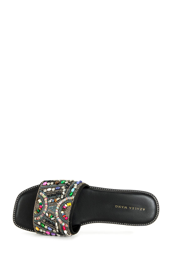 black faux leather slip on flat sandal with a colorful crystal embellished foot strap