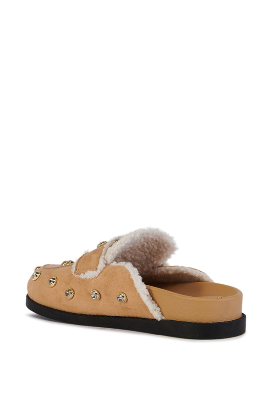 beige slip on flat mule with a faux sherpa lining and and silver studded embellishments