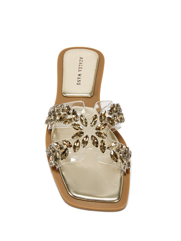top view of Gold flat sandal with a pvc strap embellished with crystal rhinestones
