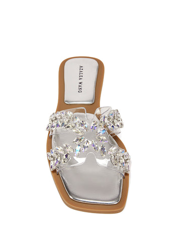 top view of silver flat sandal with a pvc strap embellished with crystal rhinestones