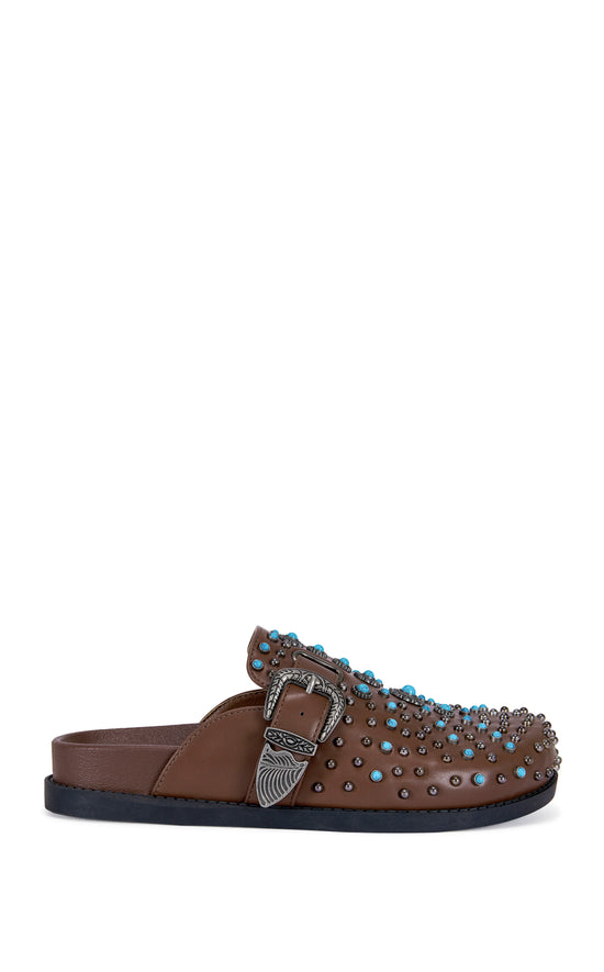 brown faux leather slip on flat mules with a western inspired belted accent with turquoise and stud embellishments