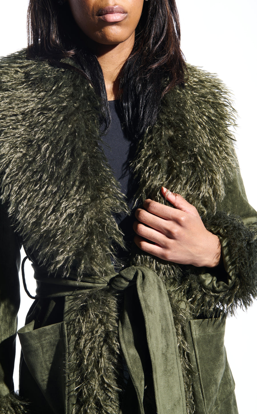olive green faux suede statement trench coat with two front pockets, a faux fur lined collar and sleeves, and a tie up waist closure