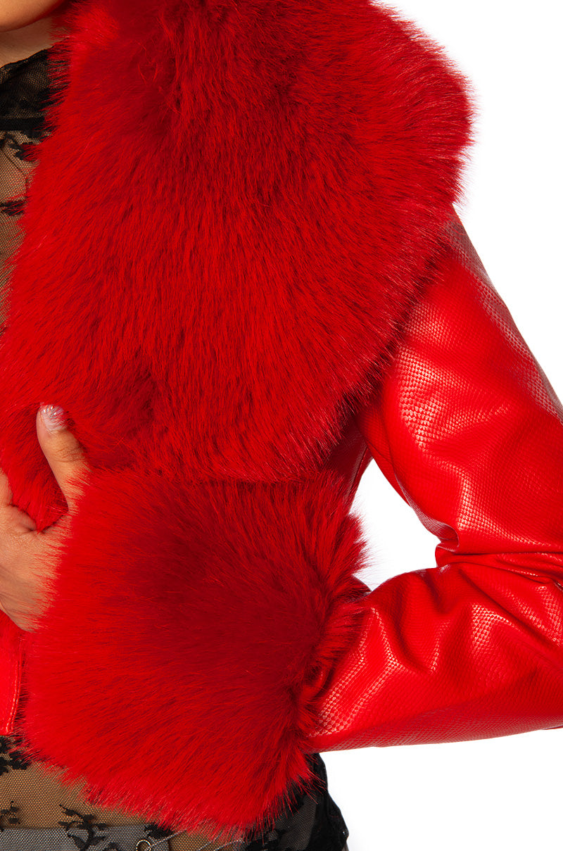 detail shot of Cherry red faux leather jacket with red faux fur collar and cuffs