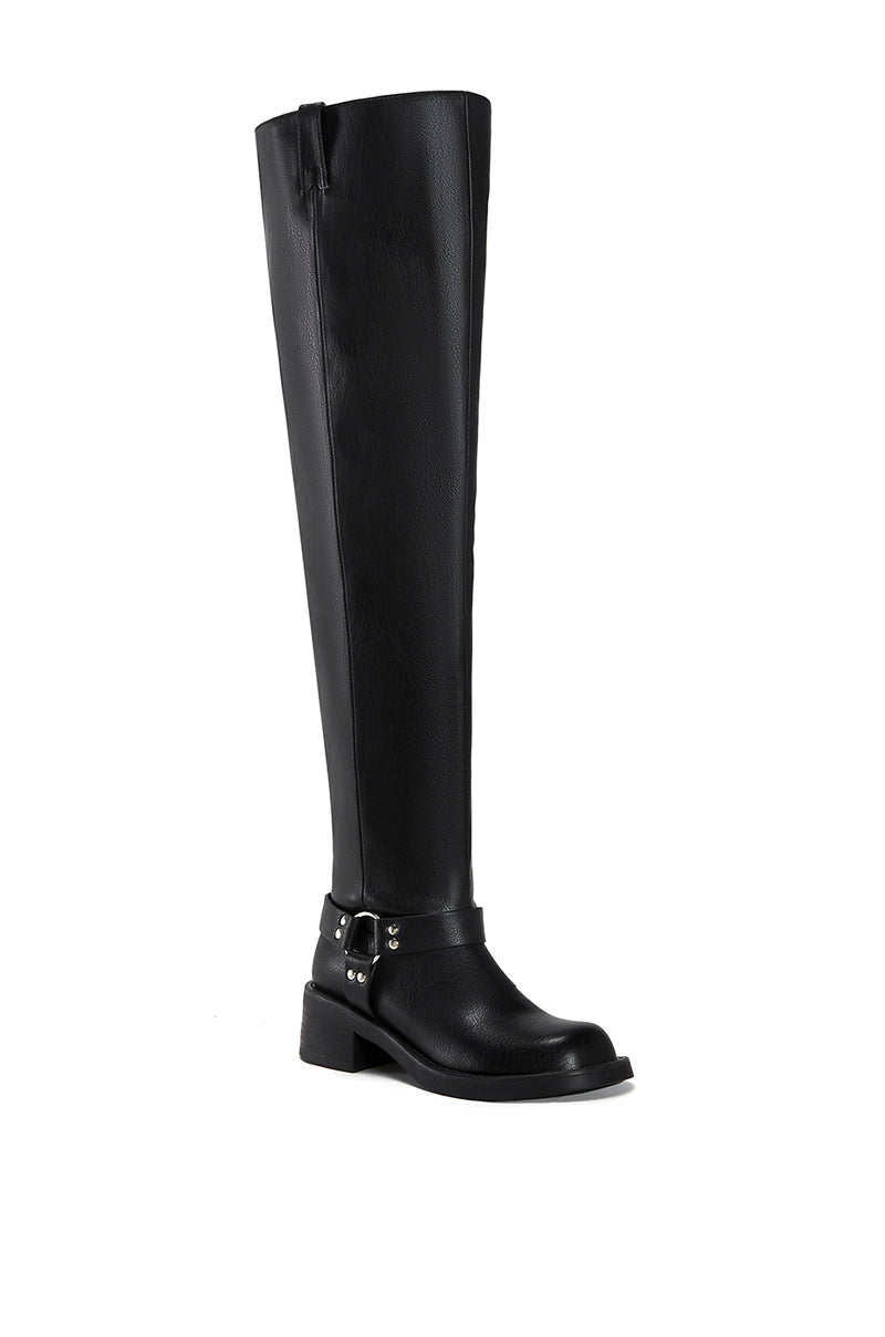 angled view of black faux leather over the knee boot with a biker boot silhouette and silver hardware accent on the ankle