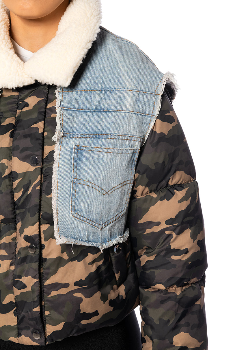detail shot of camo print cropped puffer jacket with light wash denim accent and white shearling collar