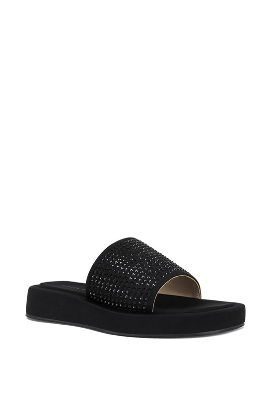 black flat slip on sandal with black rhinestone embellishments on the foot strap
