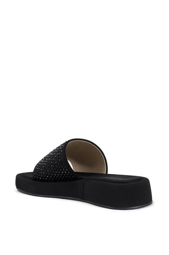 black flat slip on sandal with black rhinestone embellishments on the foot strap