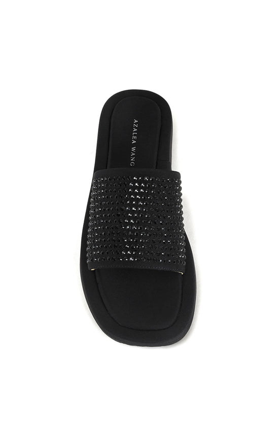 black flat slip on sandal with black rhinestone embellishments on the foot strap