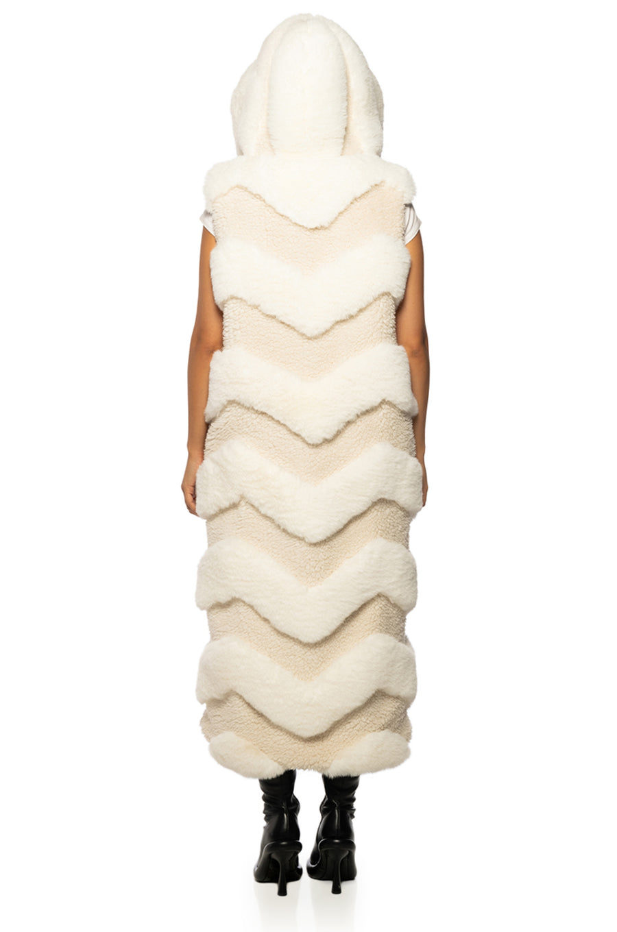 long trench style beige faux fur vest with a chevron fur pattern and a fluffy hood