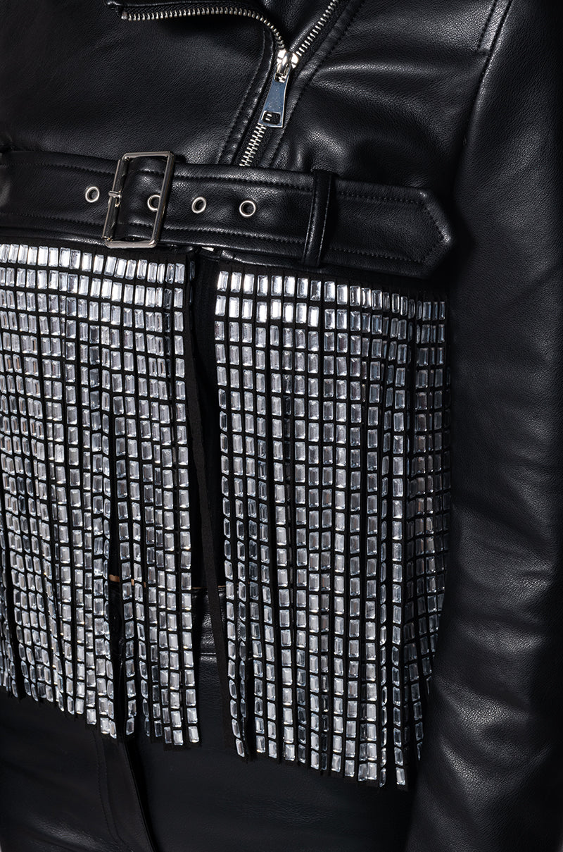 detail shot of black ultra cropped faux leather moto jacket with long crystal fringe draped along the bottom
