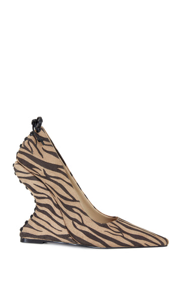 zebra print statement pumps made with faux calf hair featuring a structured wedge heel and pointed toe silhouette