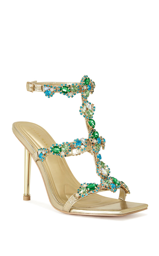 gold faux leather strappy stiletto heels with an open toe construction, adjustable ankle strap, and colorful rhinestone embellishments on the straps.