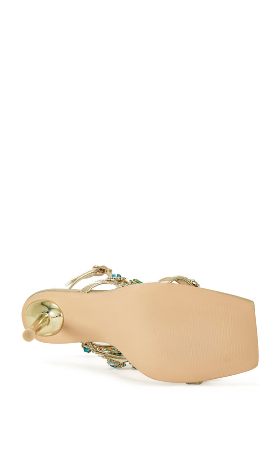 gold faux leather strappy stiletto heels with an open toe construction, adjustable ankle strap, and colorful rhinestone embellishments on the straps.