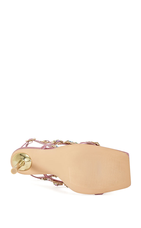 metallic pink faux leather strappy stiletto heels with an open toe construction, adjustable ankle strap, and colorful rhinestone embellishments on the straps.