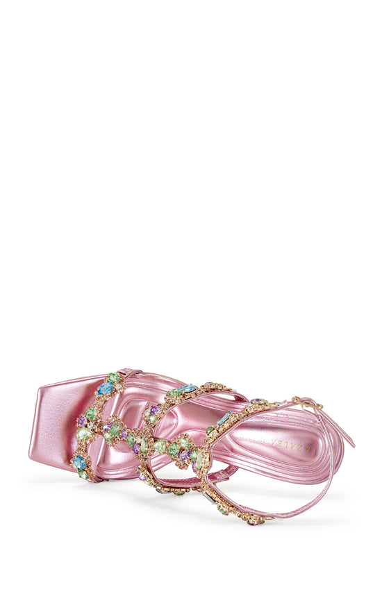 metallic pink faux leather strappy stiletto heels with an open toe construction, adjustable ankle strap, and colorful rhinestone embellishments on the straps.