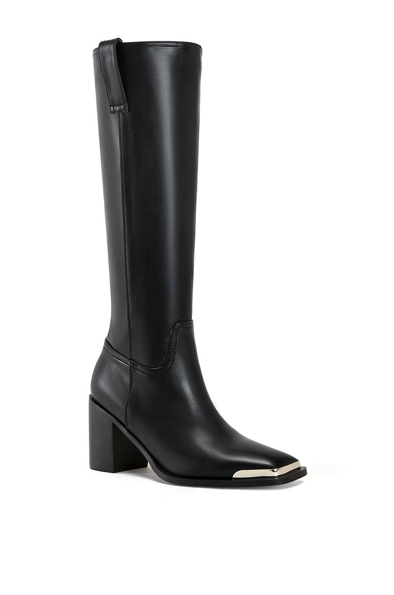 angled view of black faux leather western inspired riding boot with a silver hardware toe accent and a block heel