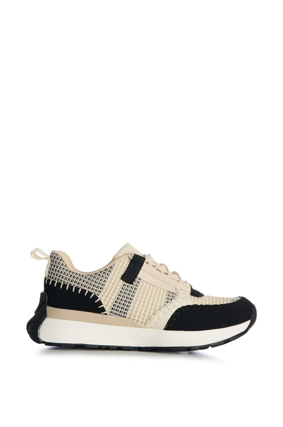 cream lace up sneakers with black stitched accents and a chunky white sole