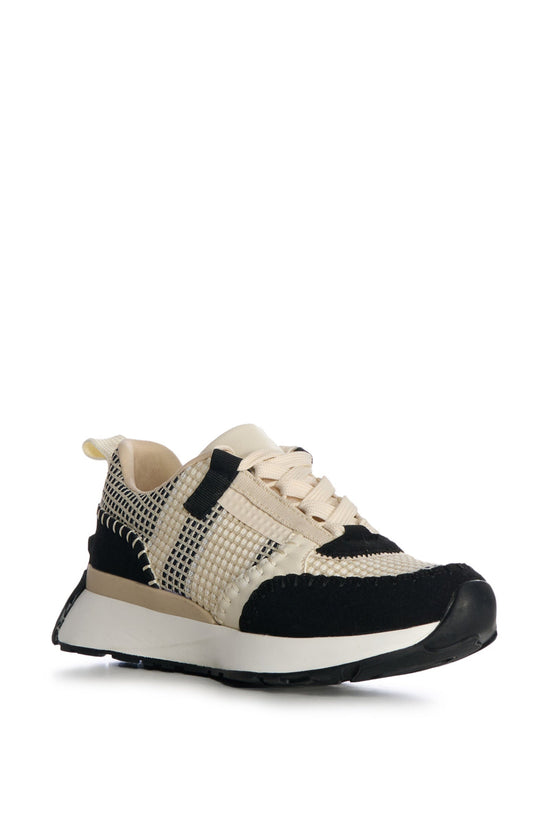 cream lace up sneakers with black stitched accents and a chunky white sole