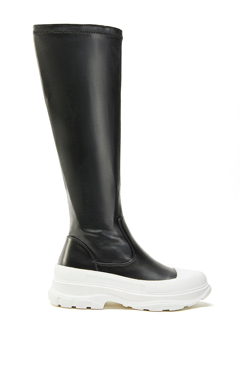 black platform faux leather knee high boots with a chunky white sole