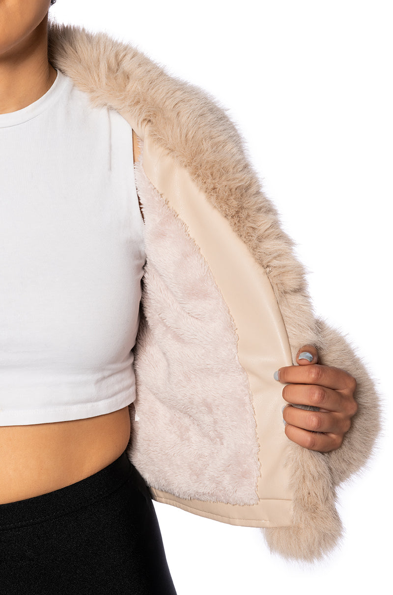 detail shot of beige cropped faux leather jacket with faux fur cuffs and collar