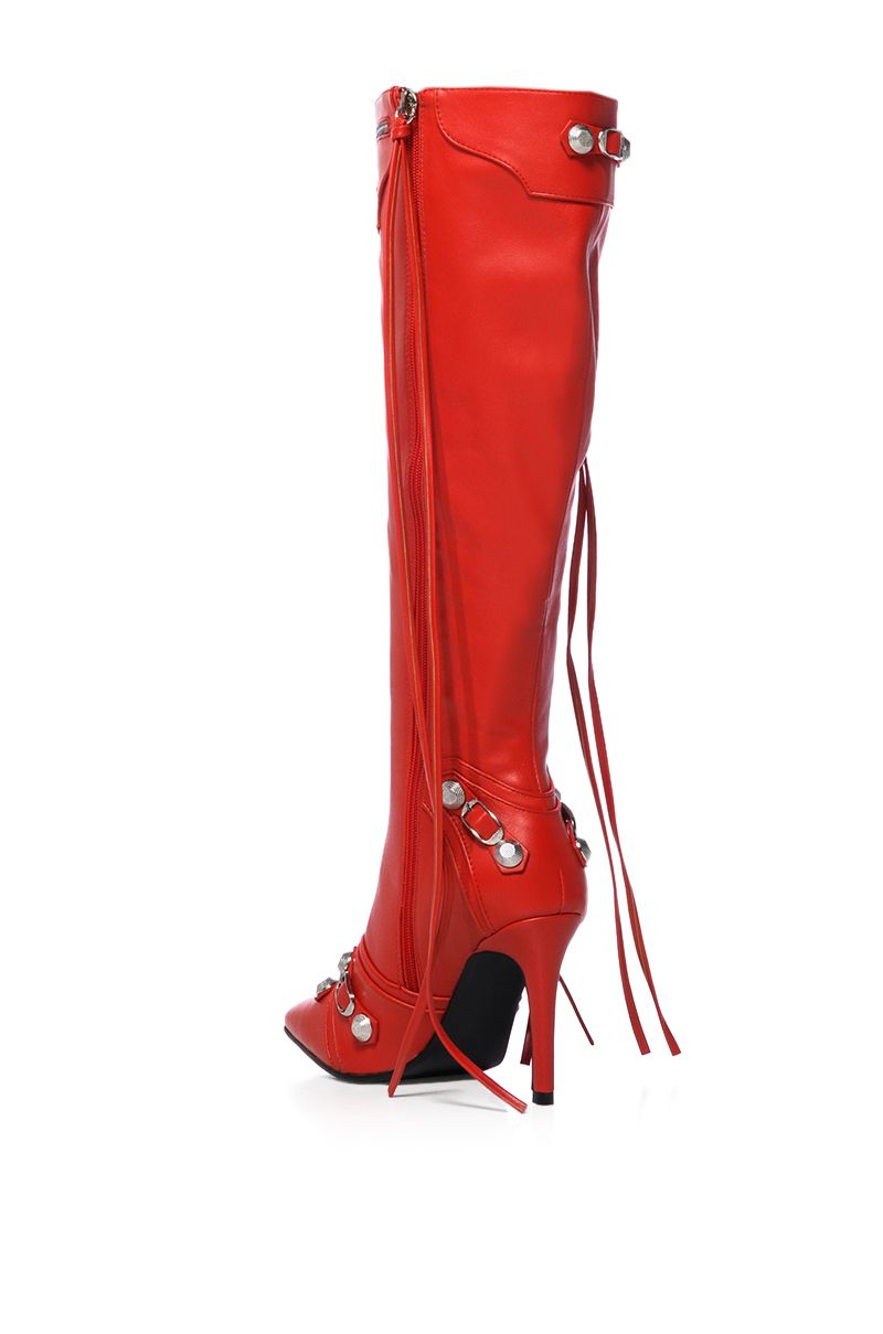 back view of mid calf length pointed toe stiletto boots made of red faux leather fabrication, including silver hardware accents and zip closer embellishments