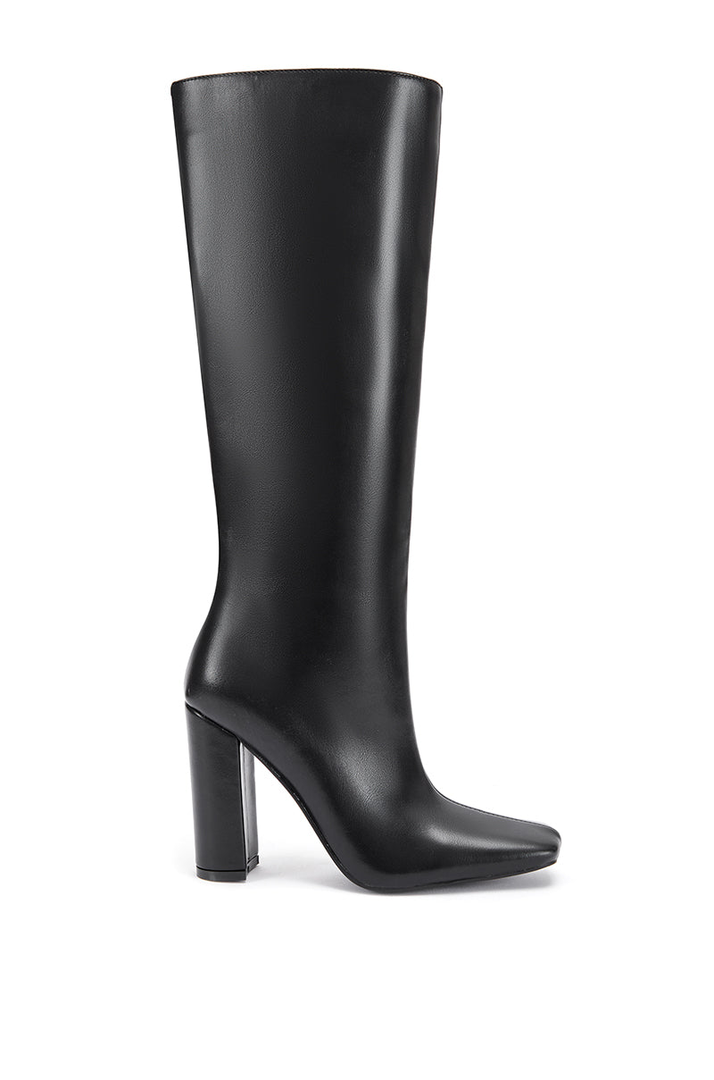 side view of black mid calf length faux leather boots with a square toe and a block heel