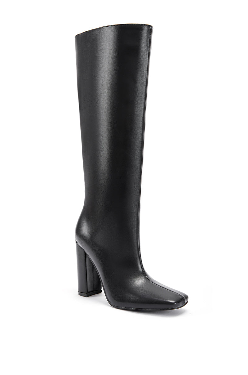 angled view of black mid calf length faux leather boots with a square toe and a block heel