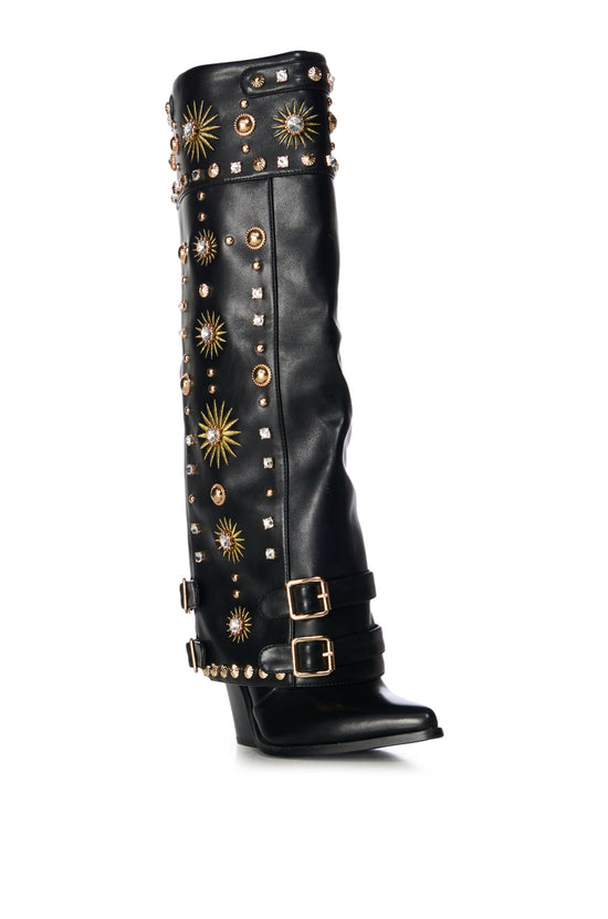 black faux leather western knee high boot with a fold over shaft stitched with sun pattern designs and embellished with gold studs and rhinestone embellishments
