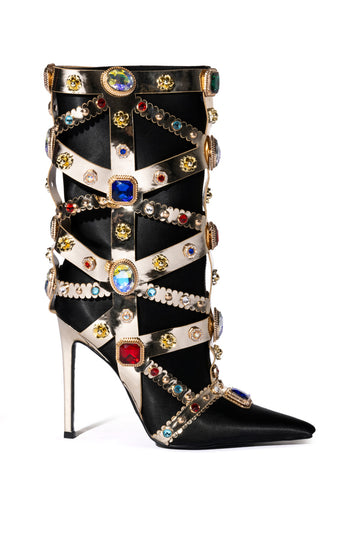 black pointed toe boots with a gold stiletto heel and gold wrap detail with multicolored rhinestone embellishment