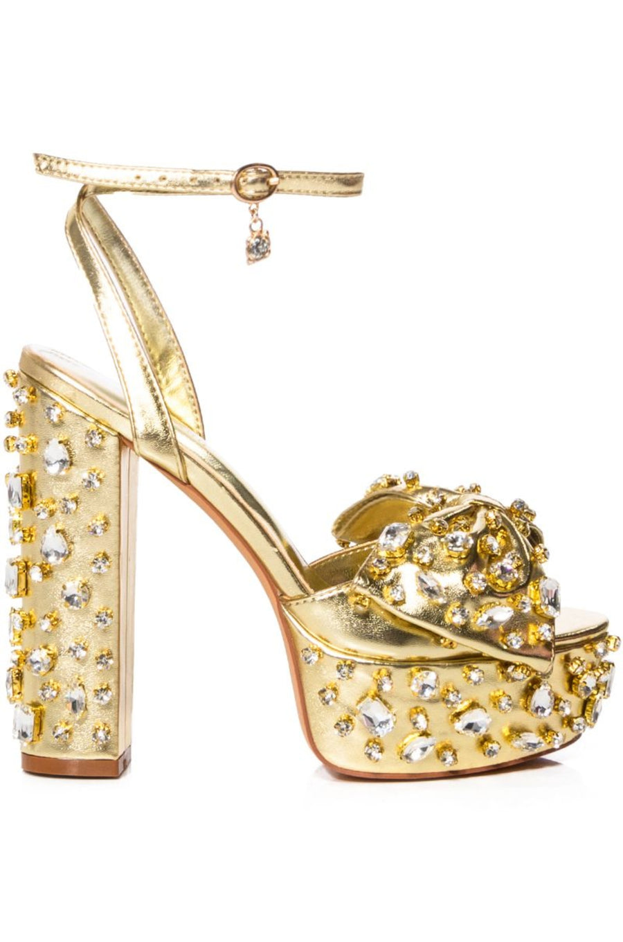 chunky gold platform heels with an open toe and gold bow detail with rhinestone embellishment