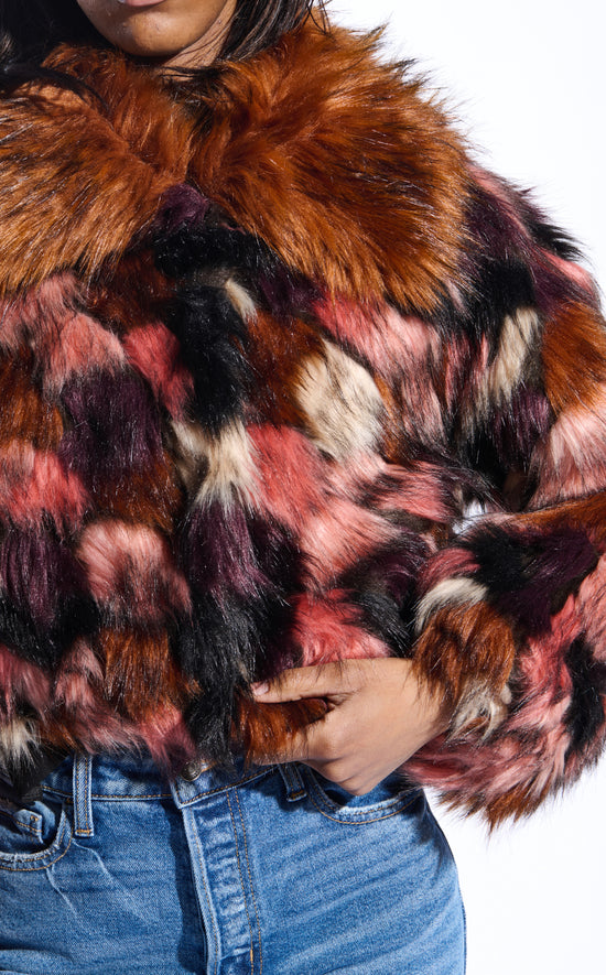 colorful pink and purple toned statement faux fur coat with a burnt orange collar and a cropped silhouette