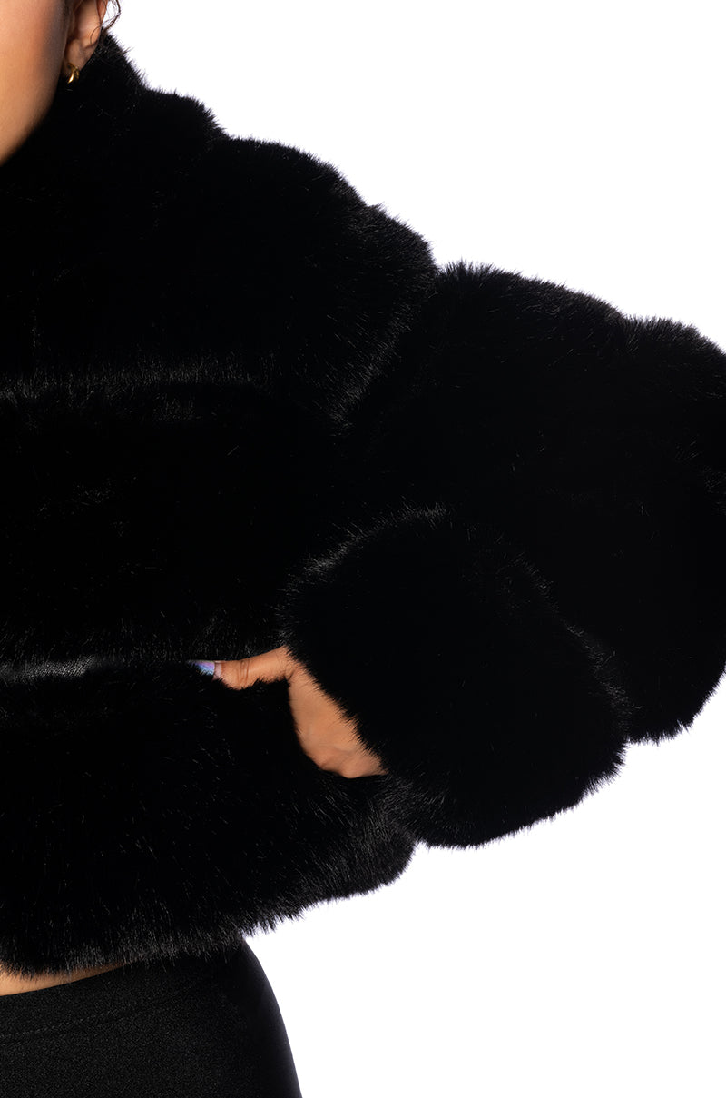 detail shot of black zip up faux fur jacket with hood