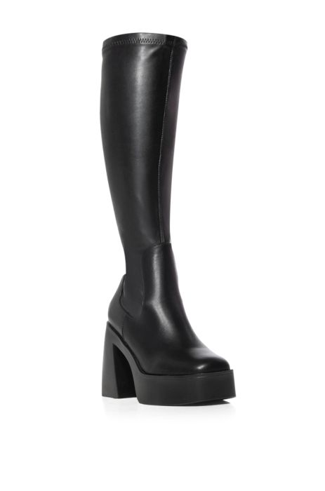 angled view of black platform faux leather knee high boots made with our 4 way stretch material