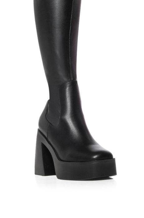 detail shot of black platform faux leather knee high boots made with our 4 way stretch material