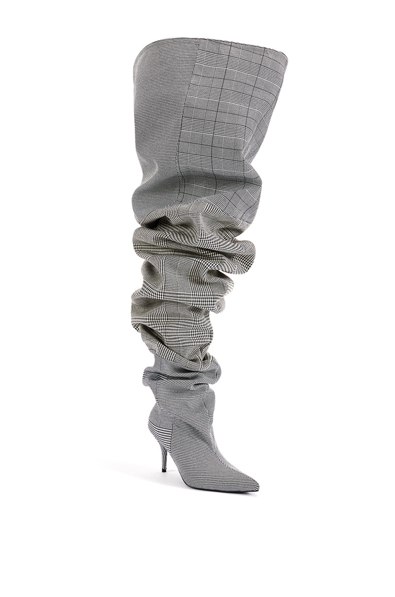 angled view of plaid patterned ruched stiletto thigh high heels with flared opening