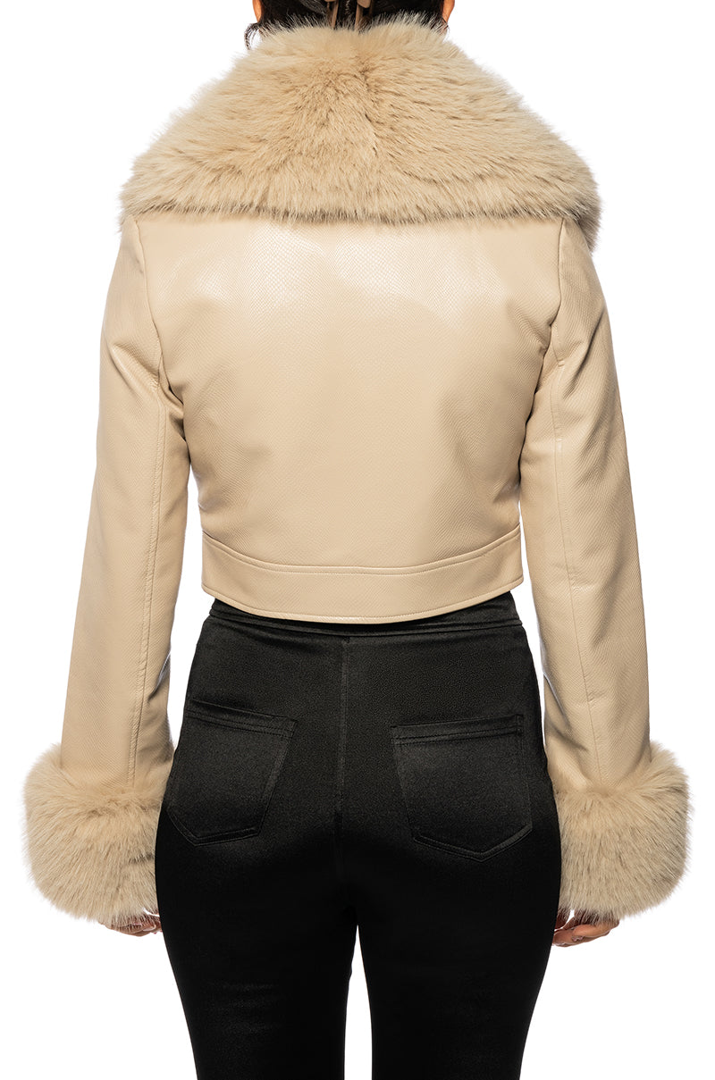 back view of Beige faux leather cropped jacked with a fluffy faux fur collar and faux fur sleeves