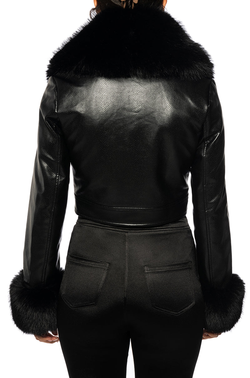 back view of Black faux leather cropped jacket with fur lined collar and fur lined cuffs